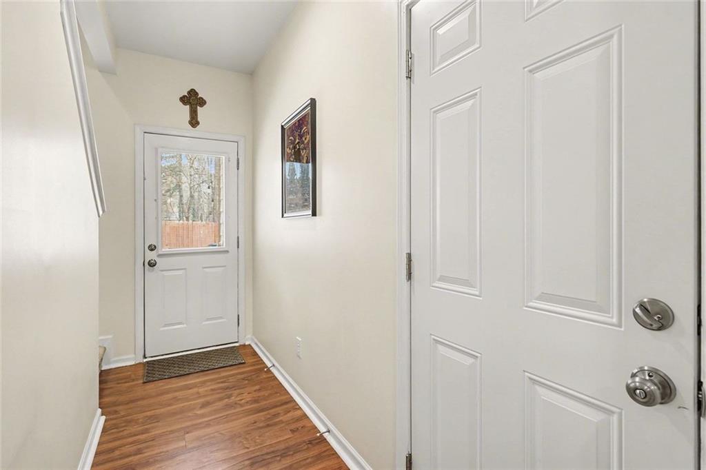 537 Ridge View Crossing Woodstock, GA 30188 - Photo 13 of 38 a view of a hallway with wooden floor and a bathroom