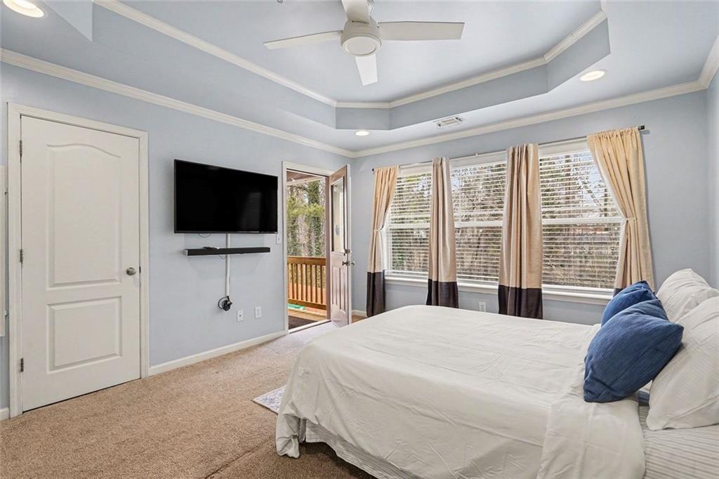 537 Ridge View Crossing Woodstock, GA 30188 - Photo 17 of 38 a bedroom with a bed and a flat screen tv