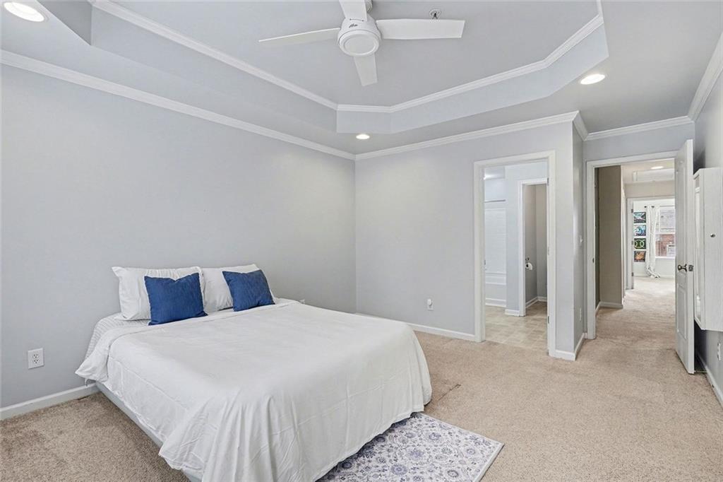 537 Ridge View Crossing Woodstock, GA 30188 - Photo 19 of 38 a bedroom with a large bed and a chandelier