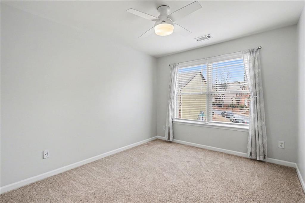 537 Ridge View Crossing Woodstock, GA 30188 - Photo 25 of 38 an empty room with a window and ceiling fan
