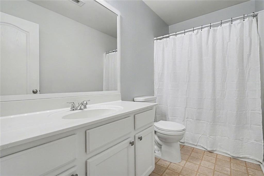537 Ridge View Crossing Woodstock, GA 30188 - Photo 27 of 38 a bathroom with a sink a toilet and shower curtain