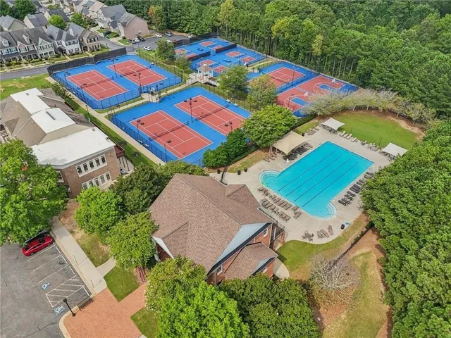 an aerial view of residential house with outdoor space and trees all around