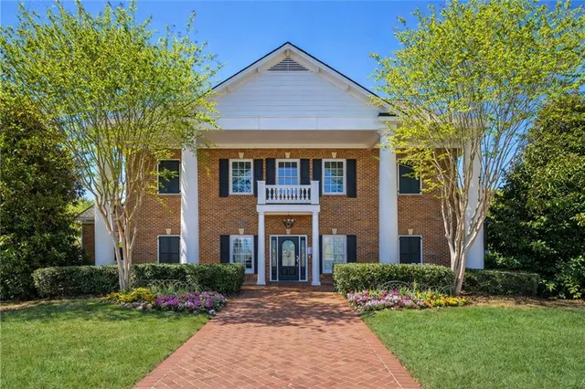 a aerial view of a tennis ground and a lake view