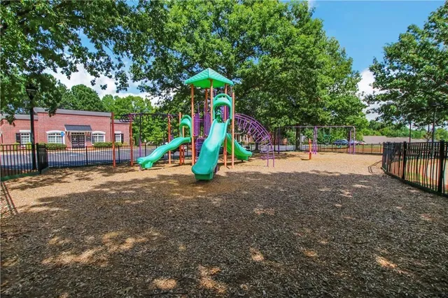 a view of a park that has a large trees with plants