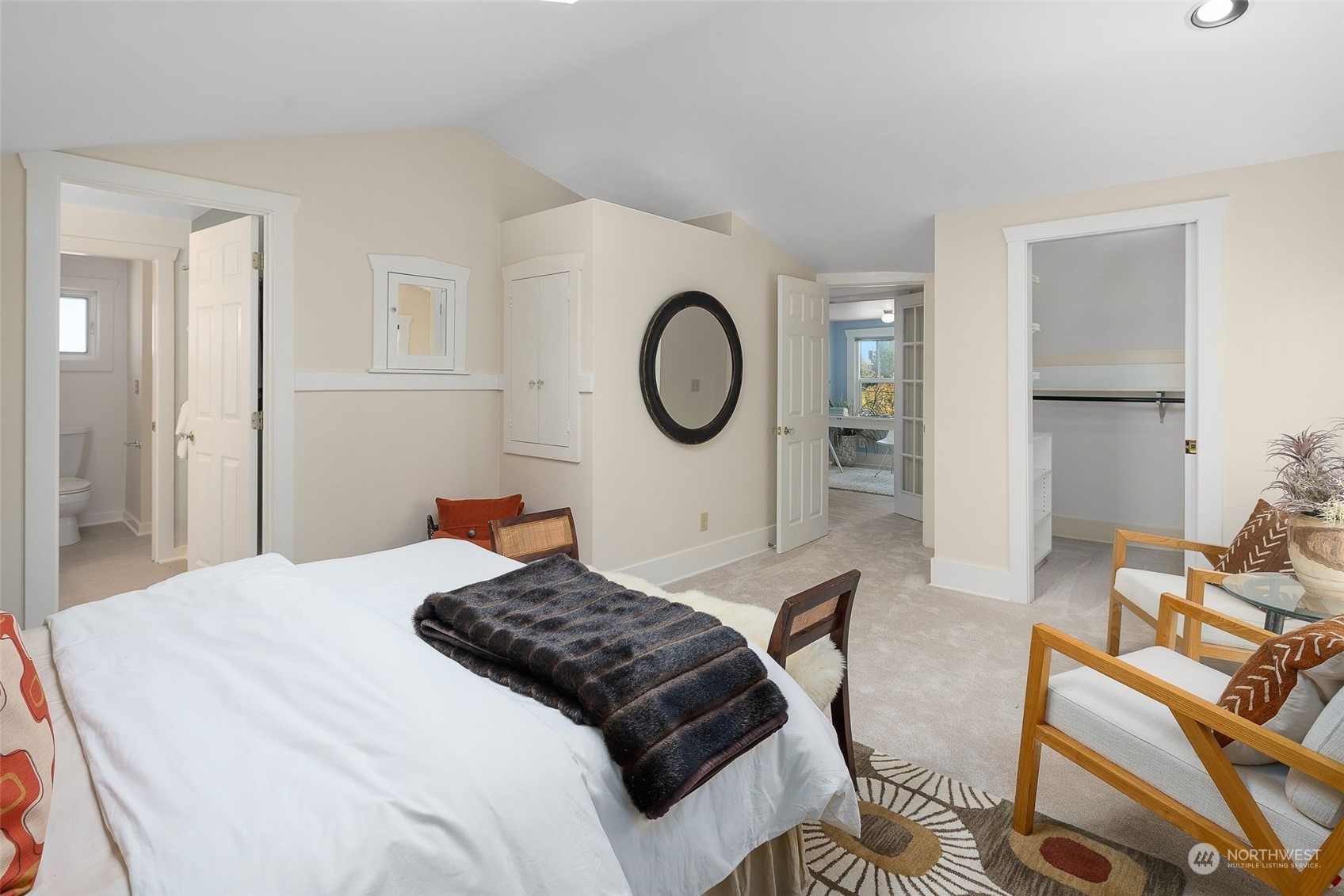 4229 Eastern Avenue North Seattle, WA 98103 - Photo 15 of 32 a bedroom with a bed a mirror and chair