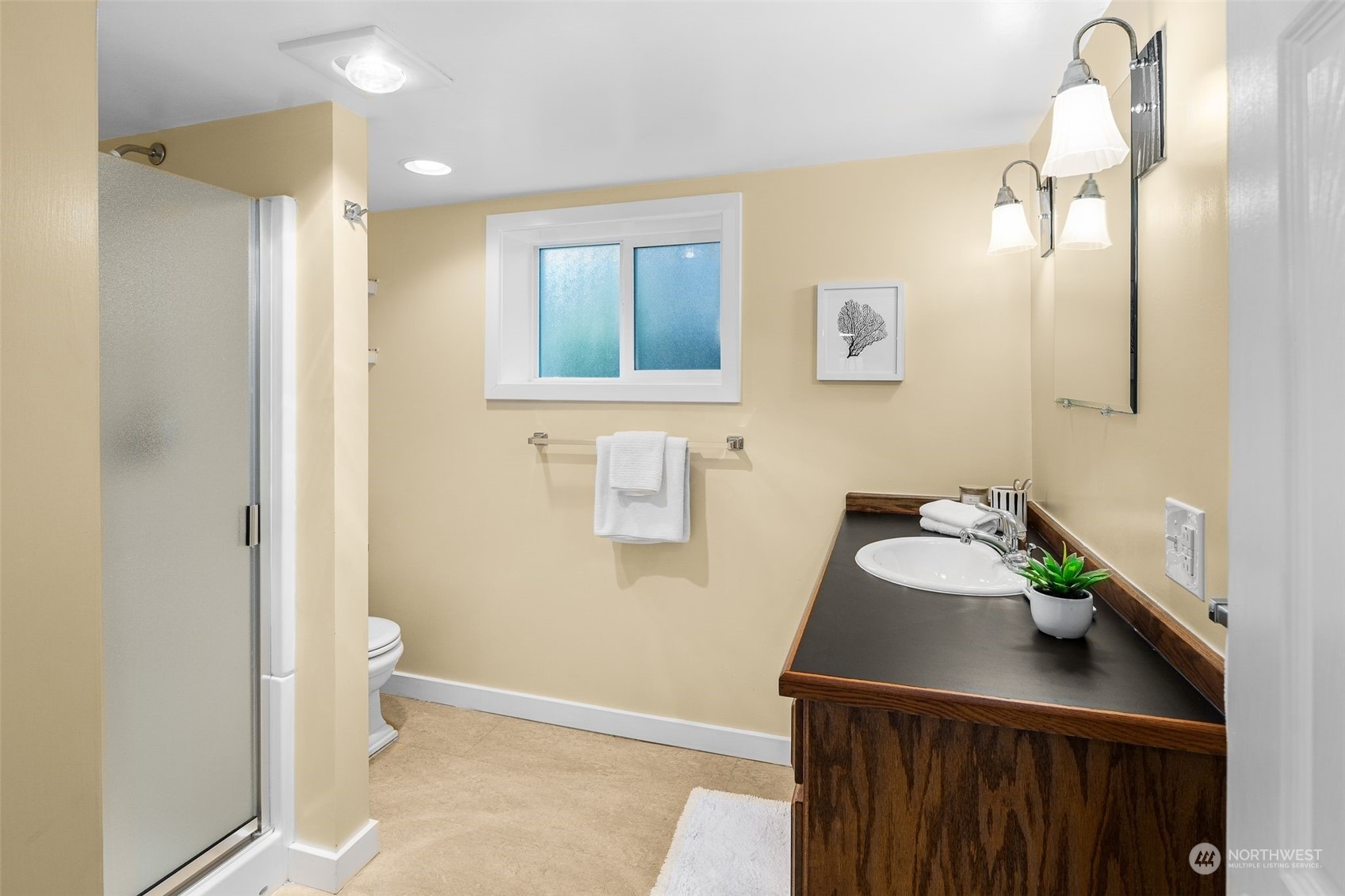 4229 Eastern Avenue North Seattle, WA 98103 - Photo 23 of 32 a bathroom with a sink a toilet and mirror