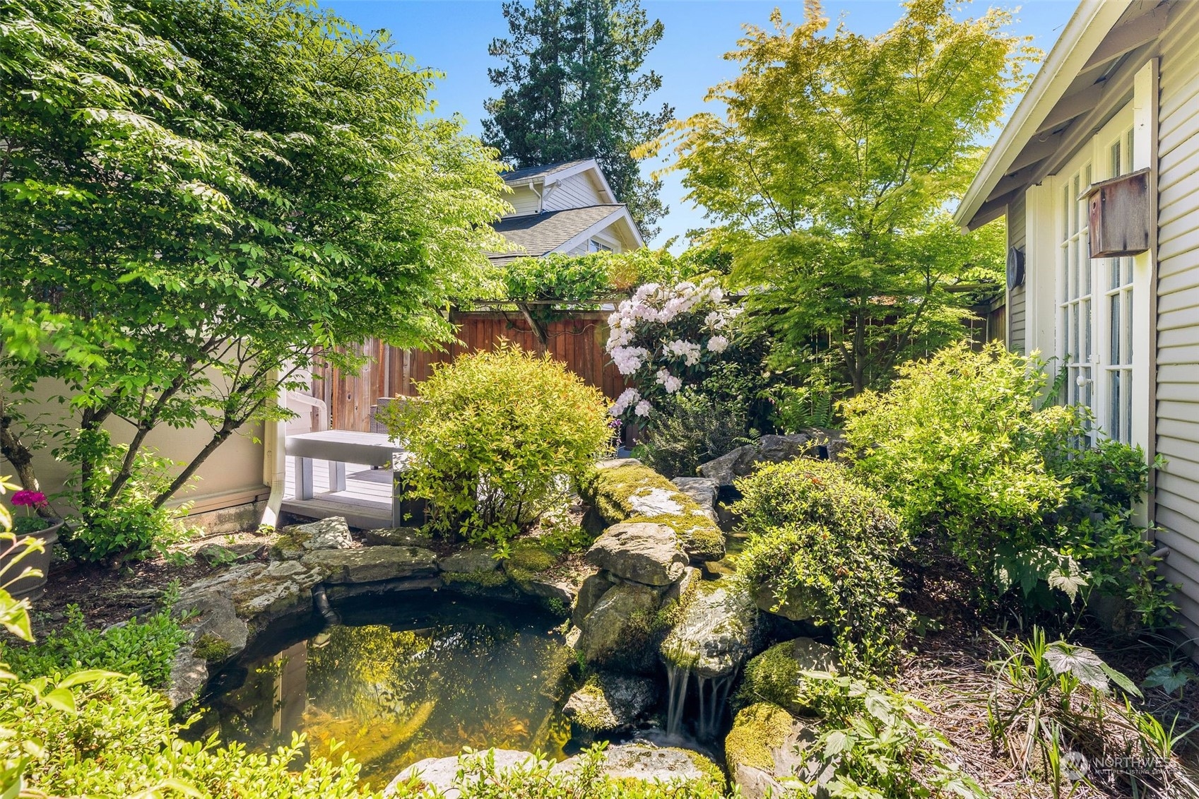 4229 Eastern Avenue North Seattle, WA 98103 - Photo 27 of 32 a swimming pool with some plants and large trees