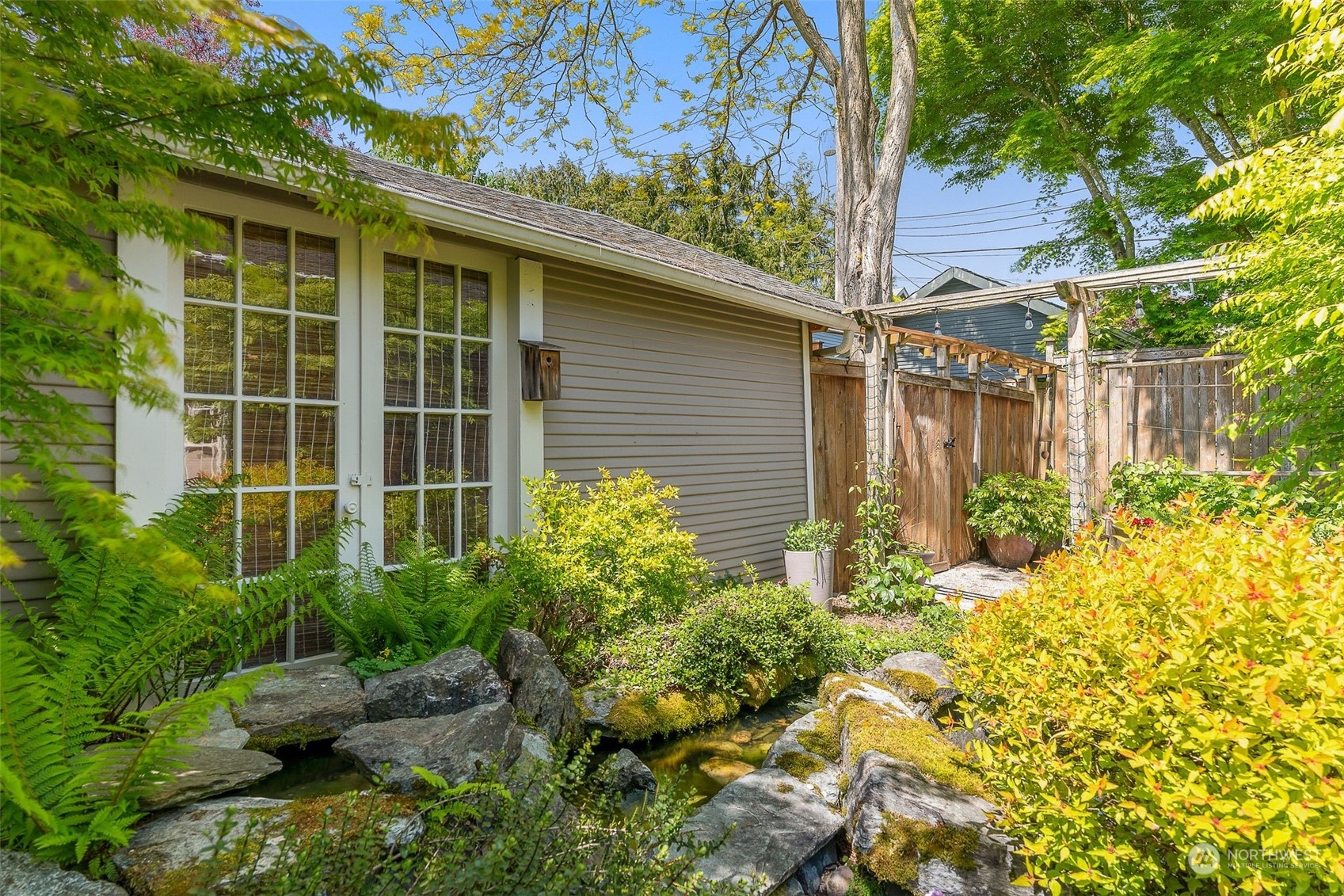 4229 Eastern Avenue North Seattle, WA 98103 - Photo 28 of 32 a view of a backyard with plants and large tree