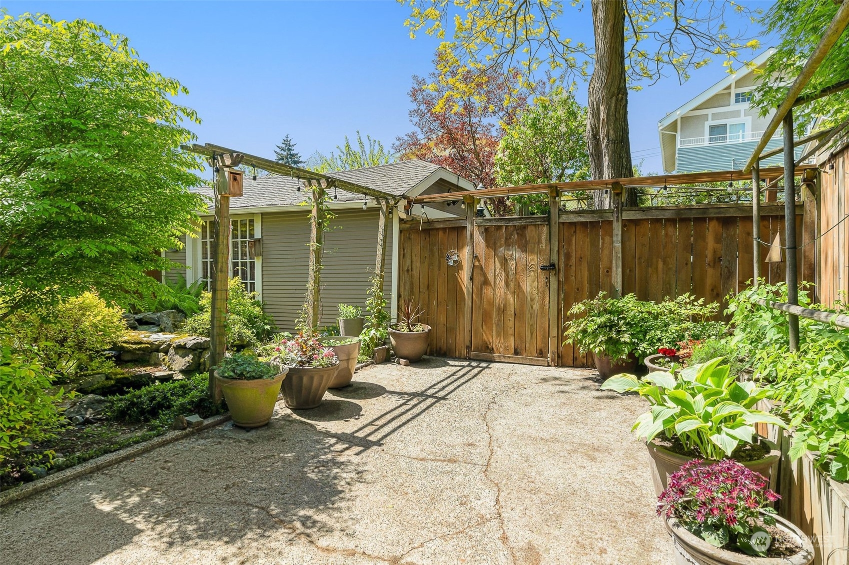 4229 Eastern Avenue North Seattle, WA 98103 - Photo 29 of 32 a view of a chair and table on the patio in front of a house