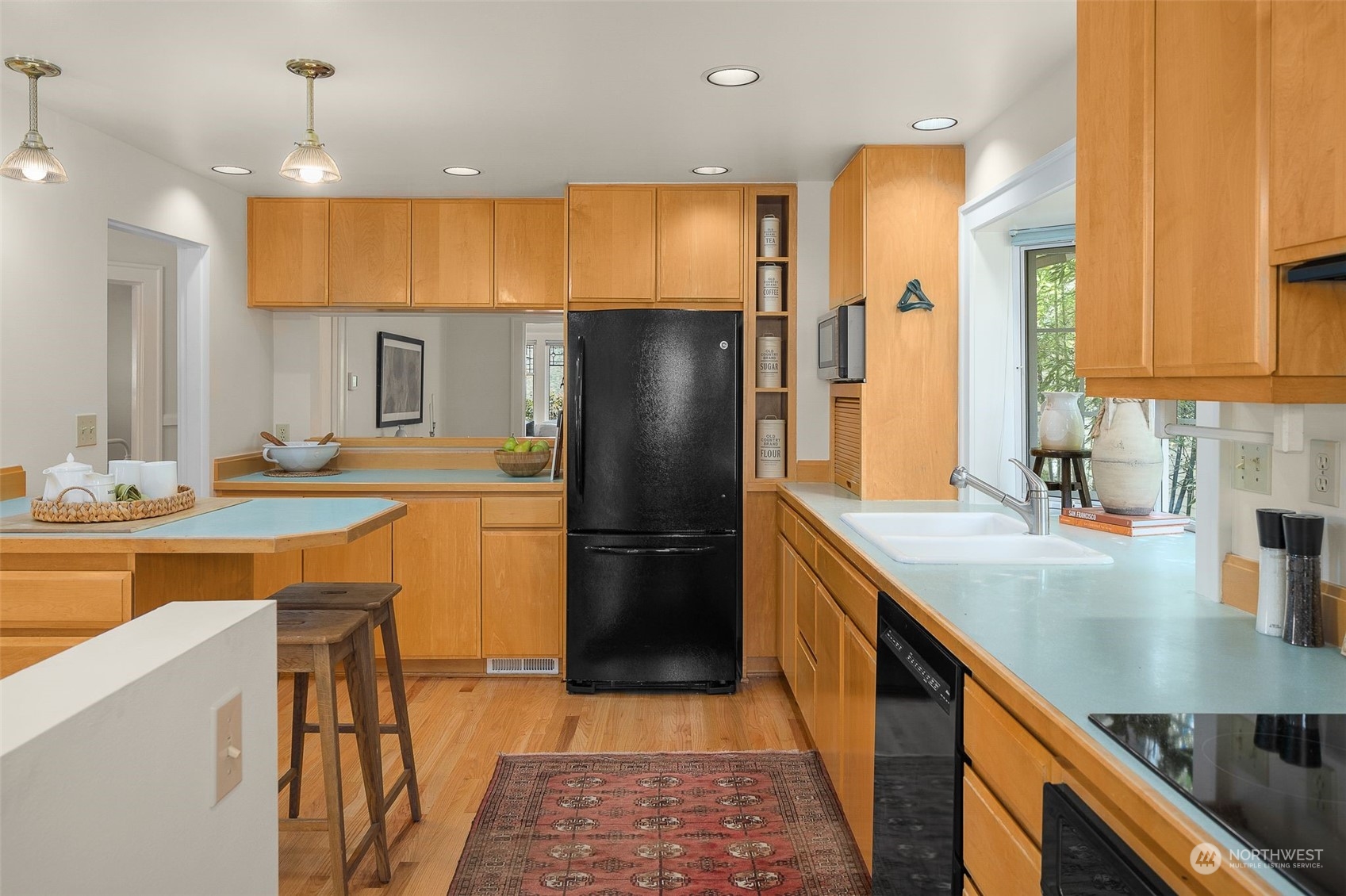 4229 Eastern Avenue North Seattle, WA 98103 - Photo 7 of 32 a kitchen with stainless steel appliances granite countertop a sink a stove and a refrigerator