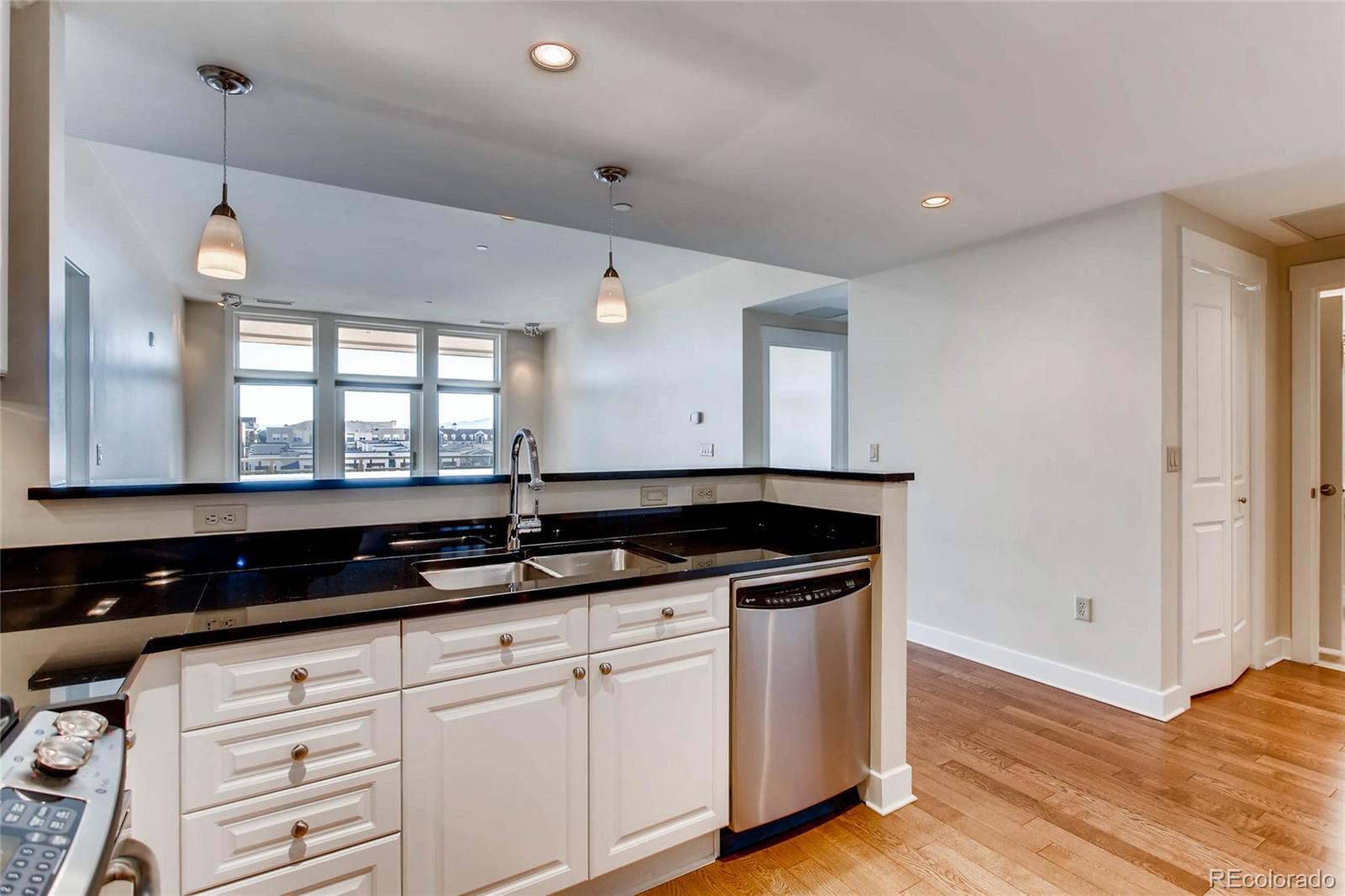 7220 W. Bonfils Lane, Unit 410 Lakewood, CO 80226 - Photo 12 of 27 a kitchen with granite countertop a sink and cabinets
