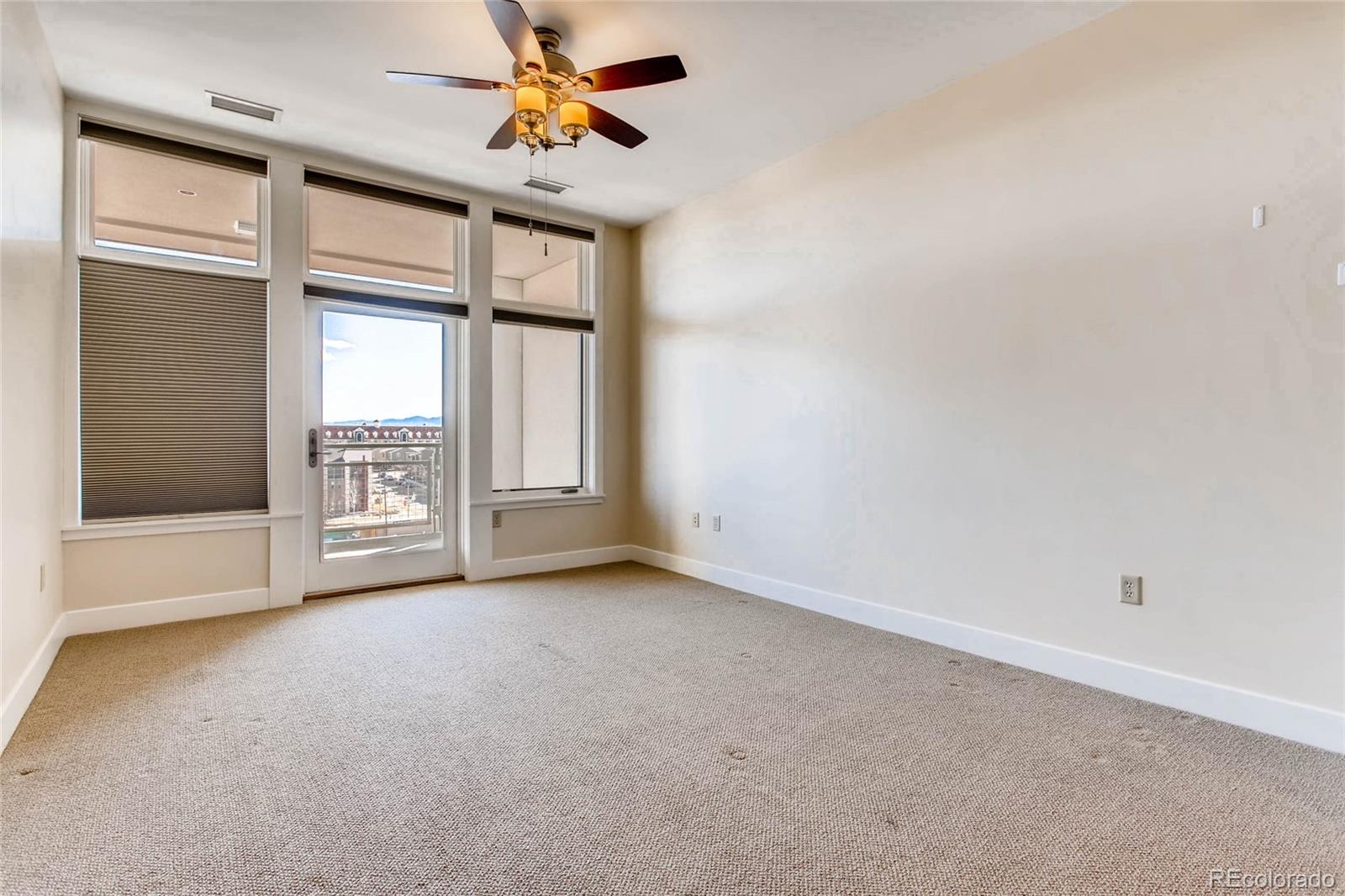 7220 W. Bonfils Lane, Unit 410 Lakewood, CO 80226 - Photo 19 of 27 an empty room with windows and fan