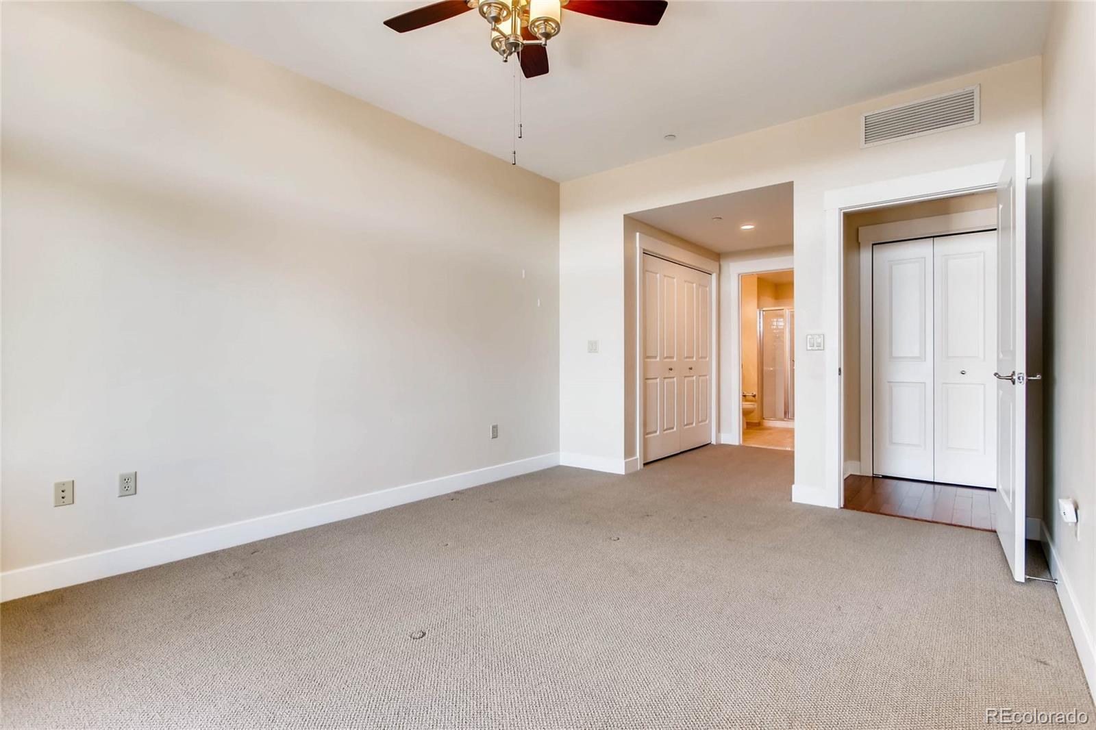 7220 W. Bonfils Lane, Unit 410 Lakewood, CO 80226 - Photo 20 of 27 an empty room with a ceiling fan and glass window