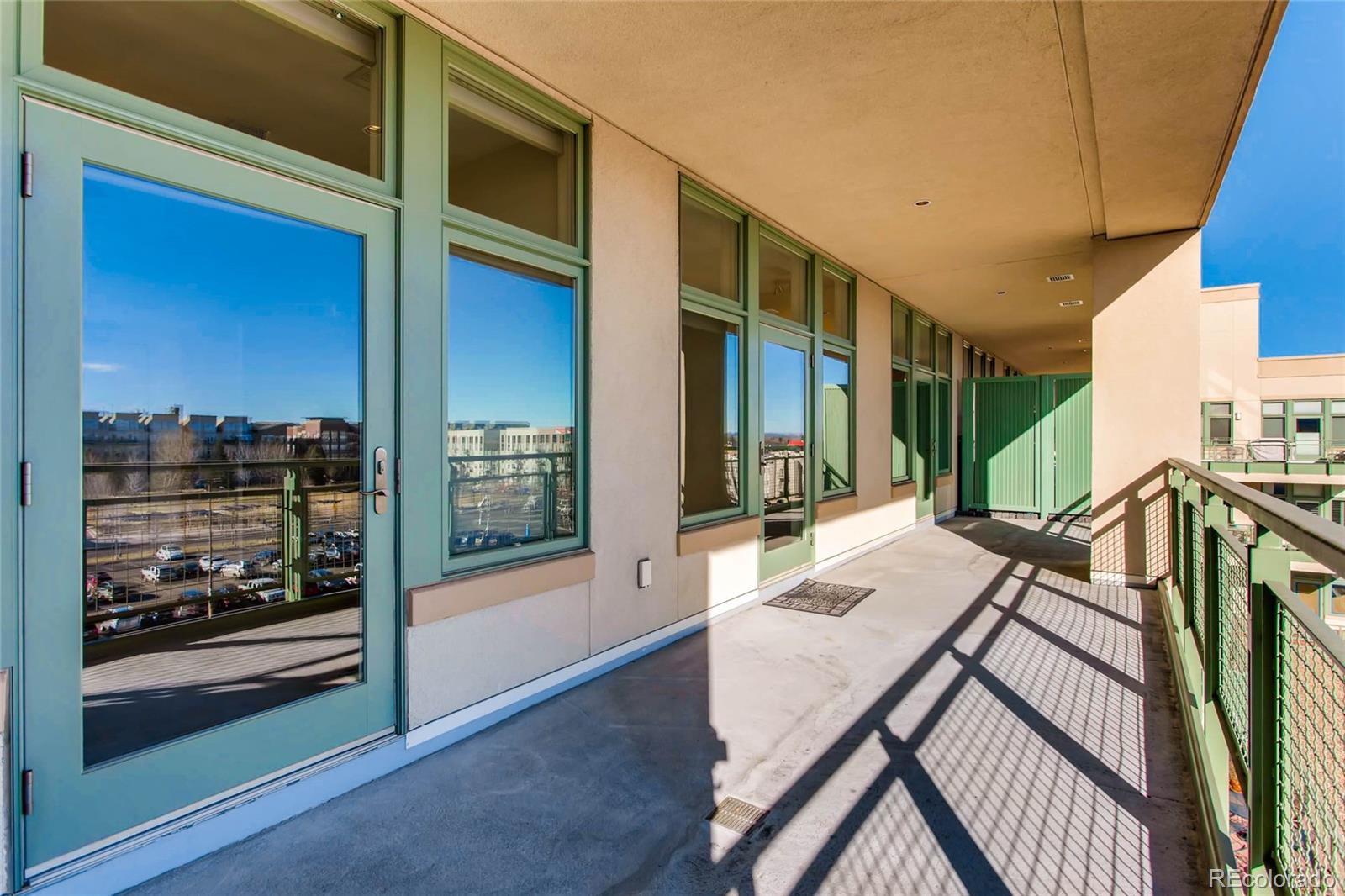 7220 W. Bonfils Lane, Unit 410 Lakewood, CO 80226 - Photo 22 of 27 a balcony view with a large window and couch