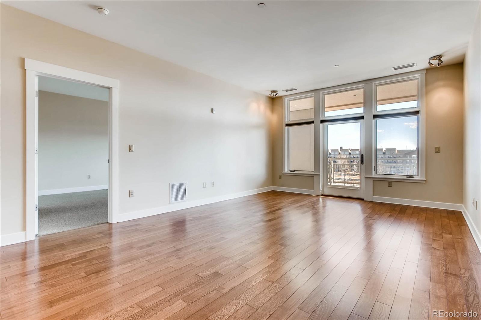 7220 W. Bonfils Lane, Unit 410 Lakewood, CO 80226 - Photo 6 of 27 wooden floor in an empty room with a window
