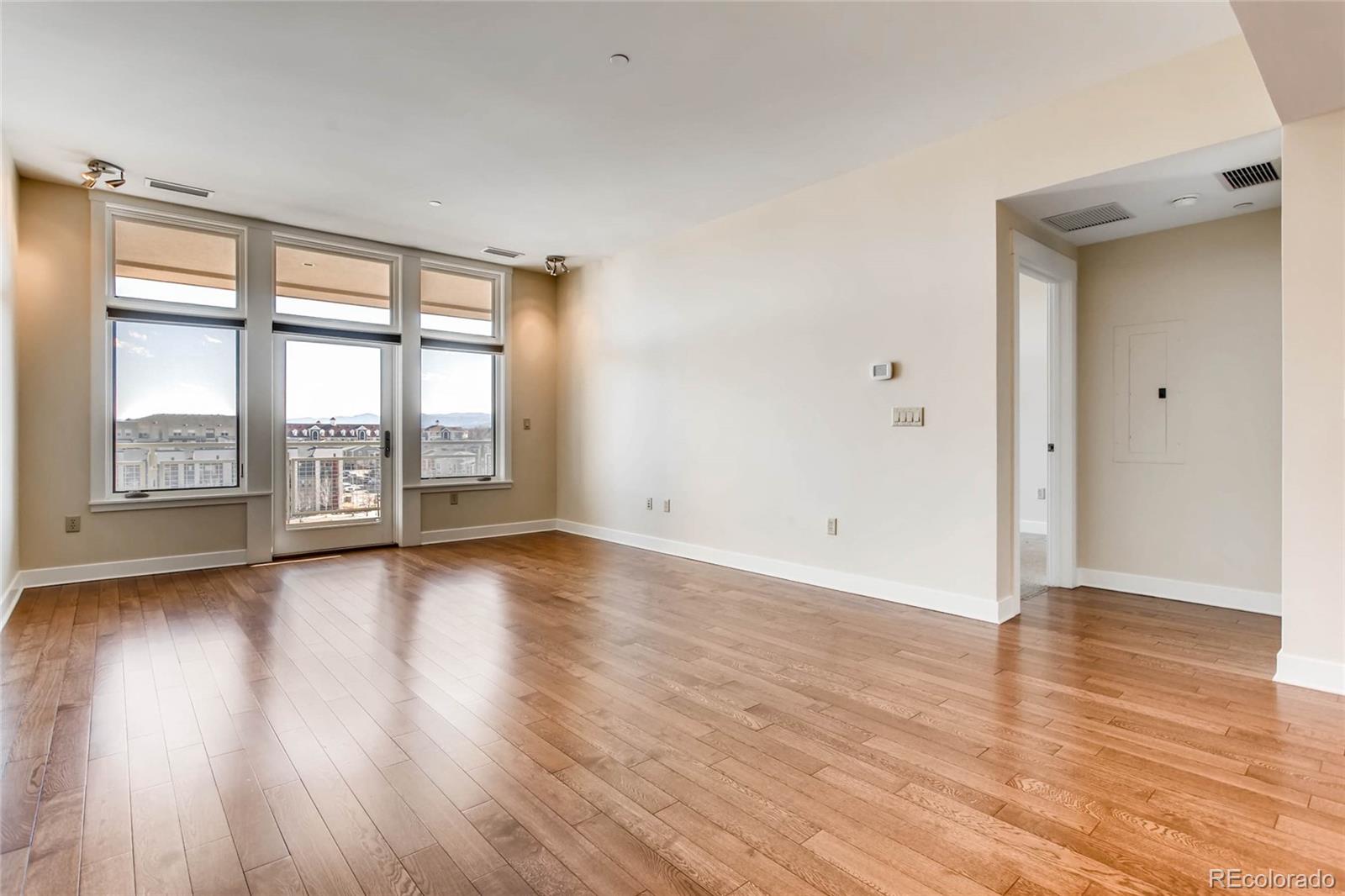 7220 W. Bonfils Lane, Unit 410 Lakewood, CO 80226 - Photo 7 of 27 a view of an empty room with wooden floor and a window