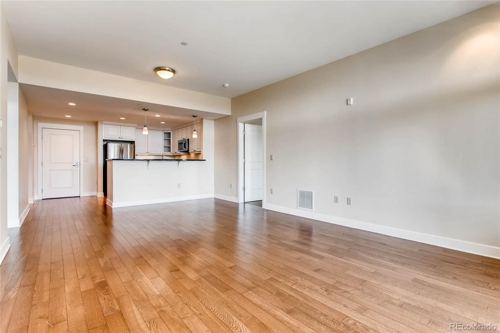 7220 W. Bonfils Lane, Unit 410 Lakewood, CO 80226 - Photo 9 of 27 a view of a kitchen with a sink and a refrigerator