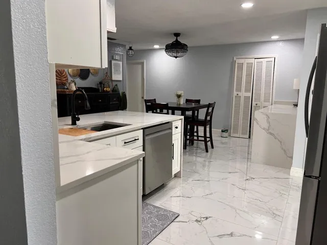 a kitchen with a stove cabinets and a refrigerator