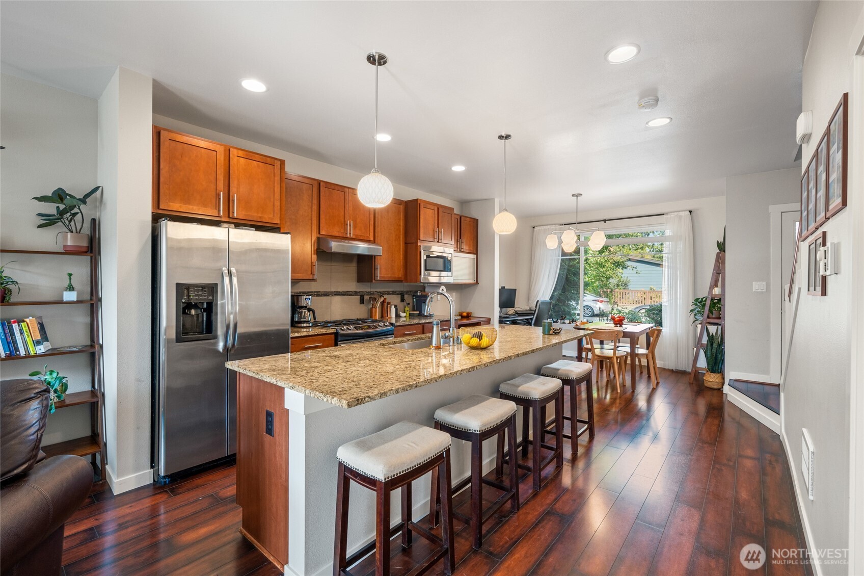 3013 South Nevada Street Seattle, WA 98108 - Photo 7 of 33 a kitchen with stainless steel appliances granite countertop dining table chairs refrigerator and sink