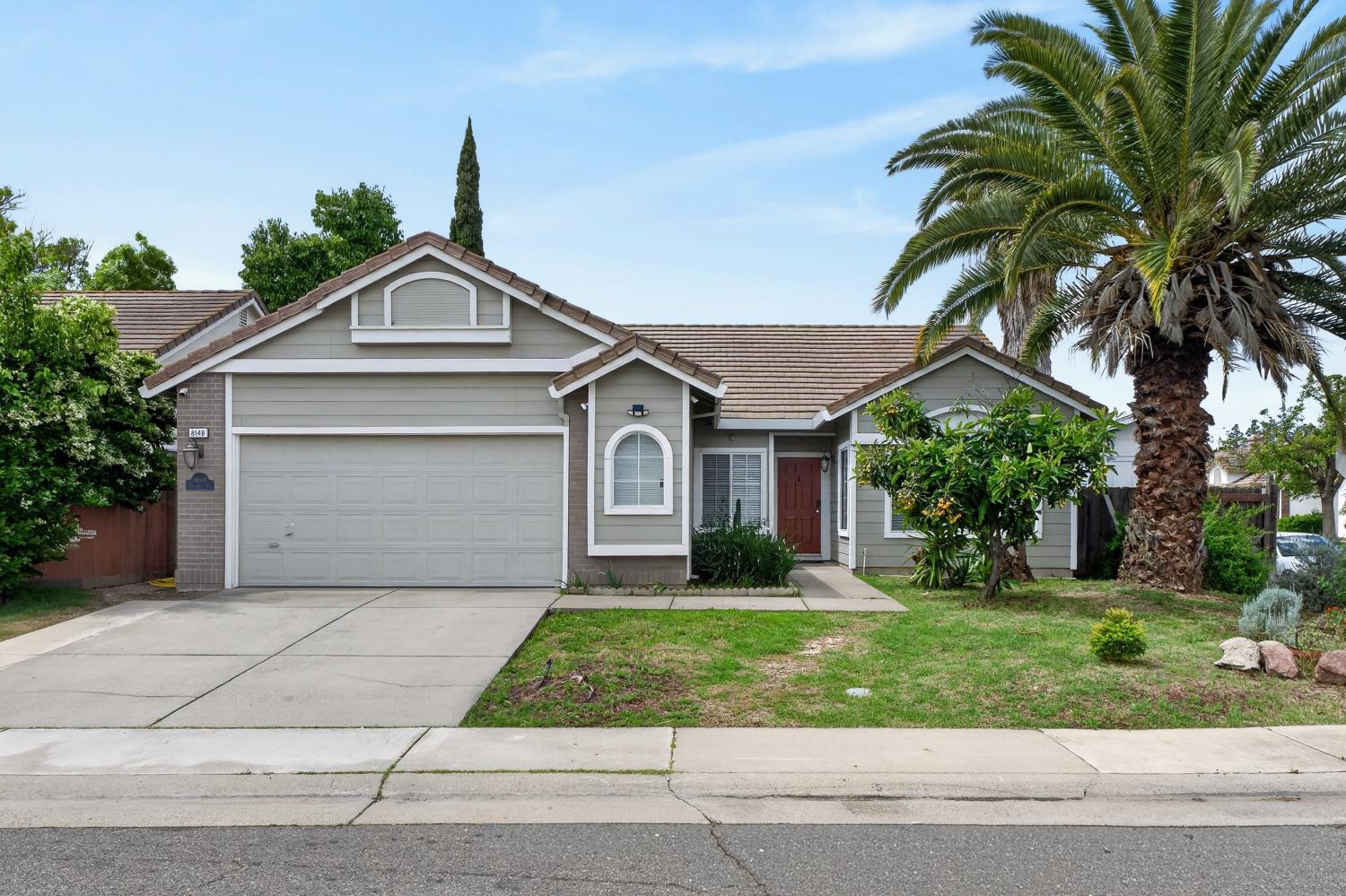 a front view of a house with a garden