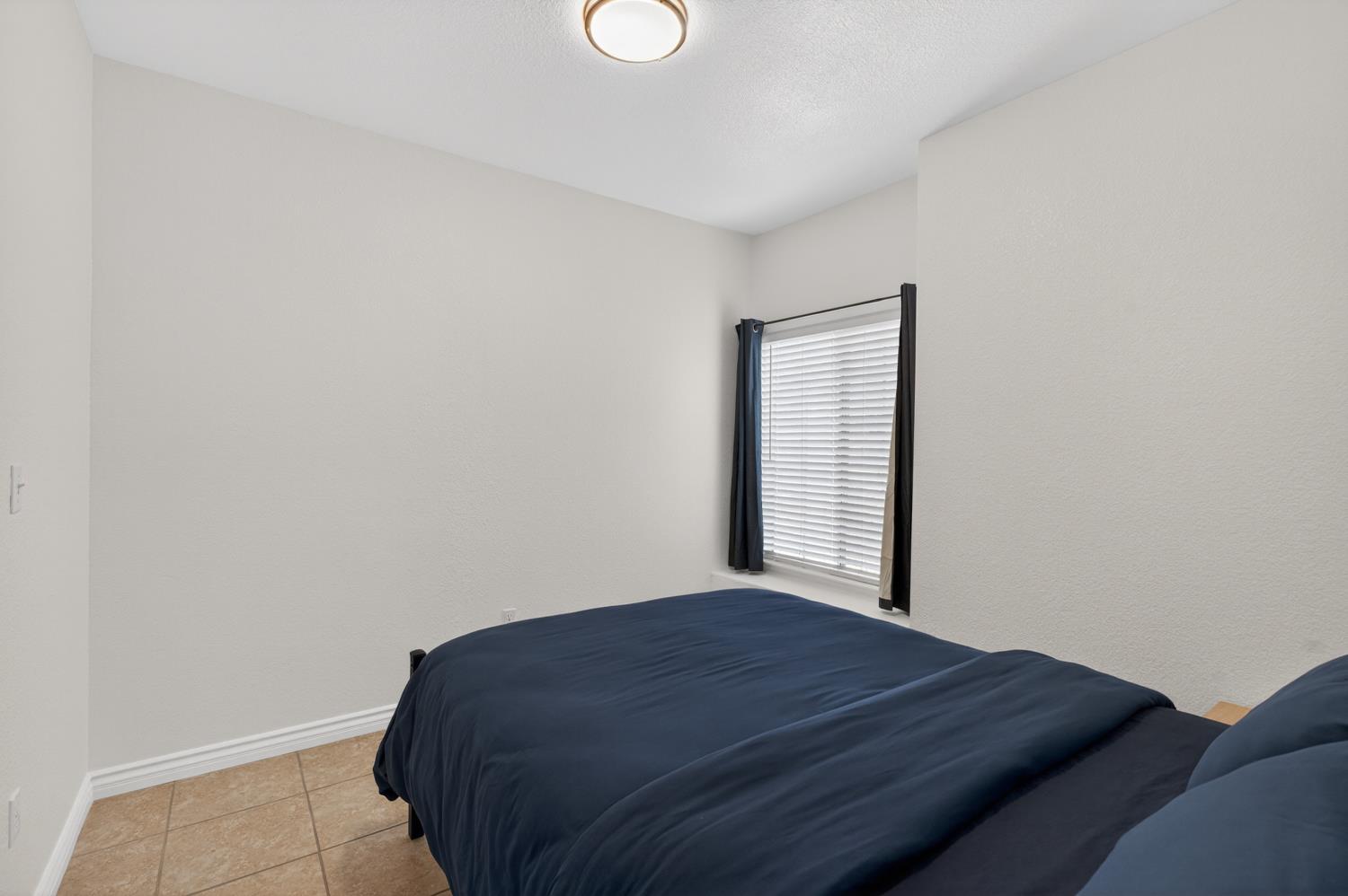8148 Silverleaf Way Sacramento, CA 95829 - Photo 12 of 43 a bedroom with a bed and a window