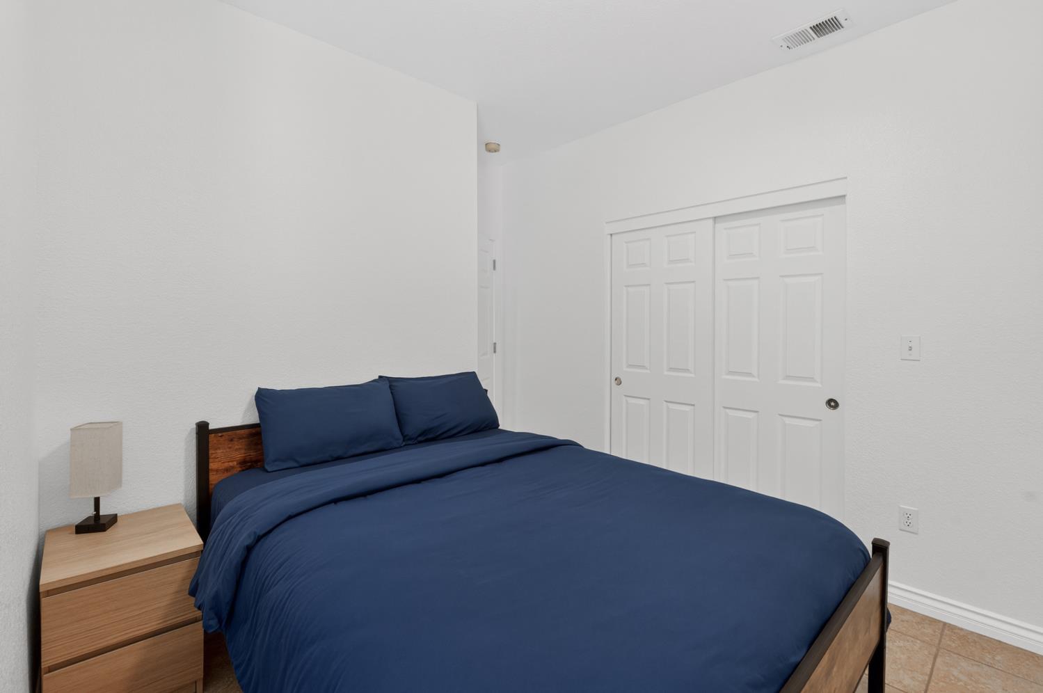 8148 Silverleaf Way Sacramento, CA 95829 - Photo 13 of 43 a bed sitting in a bedroom next to a cabinet