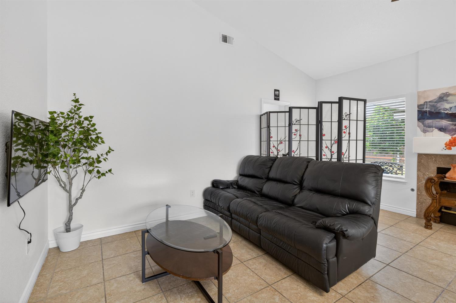 8148 Silverleaf Way Sacramento, CA 95829 - Photo 18 of 43 a living room with furniture and a potted plant