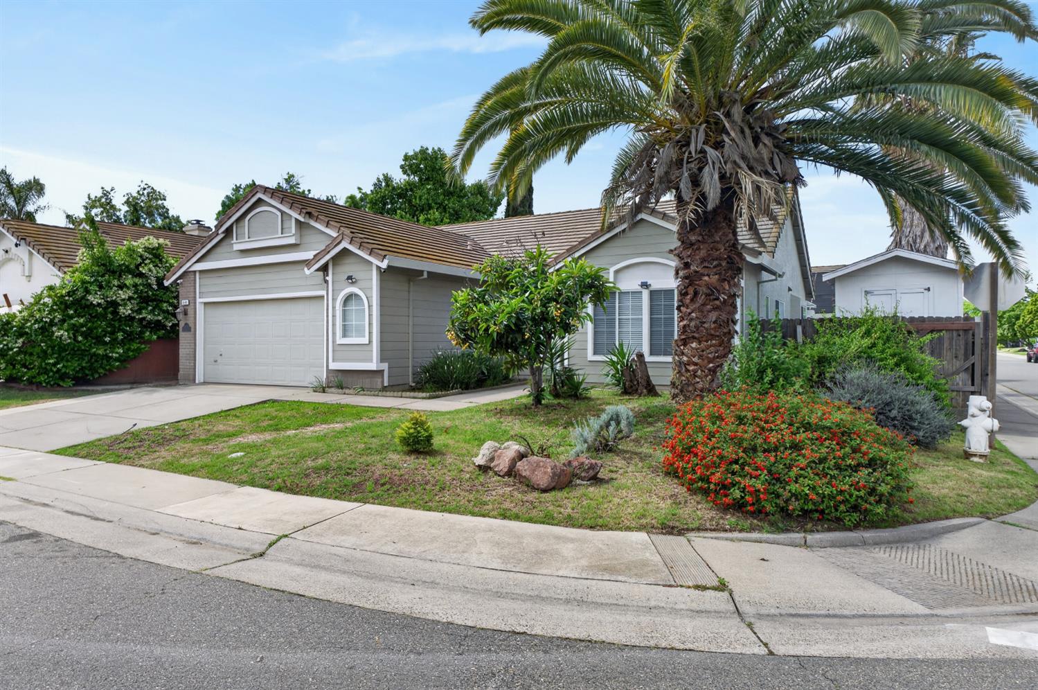 8148 Silverleaf Way Sacramento, CA 95829 - Photo 2 of 43 a front view of a house with a garden