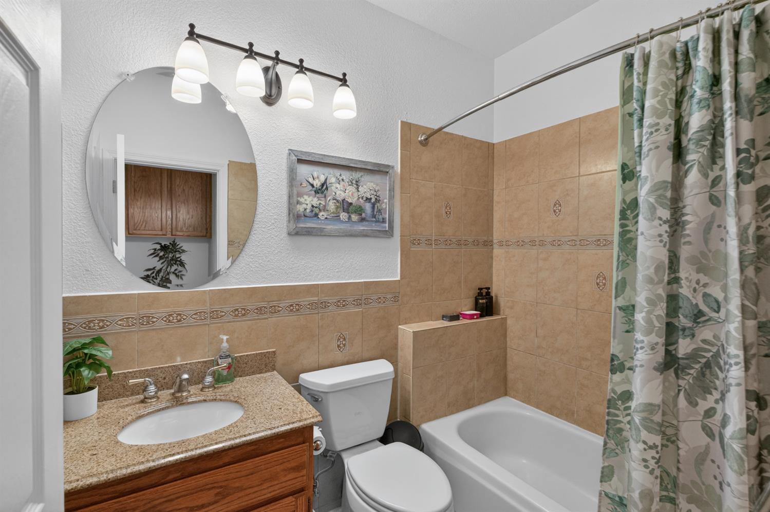 8148 Silverleaf Way Sacramento, CA 95829 - Photo 8 of 43 a bathroom with a sink a toilet a mirror a vanity and shower