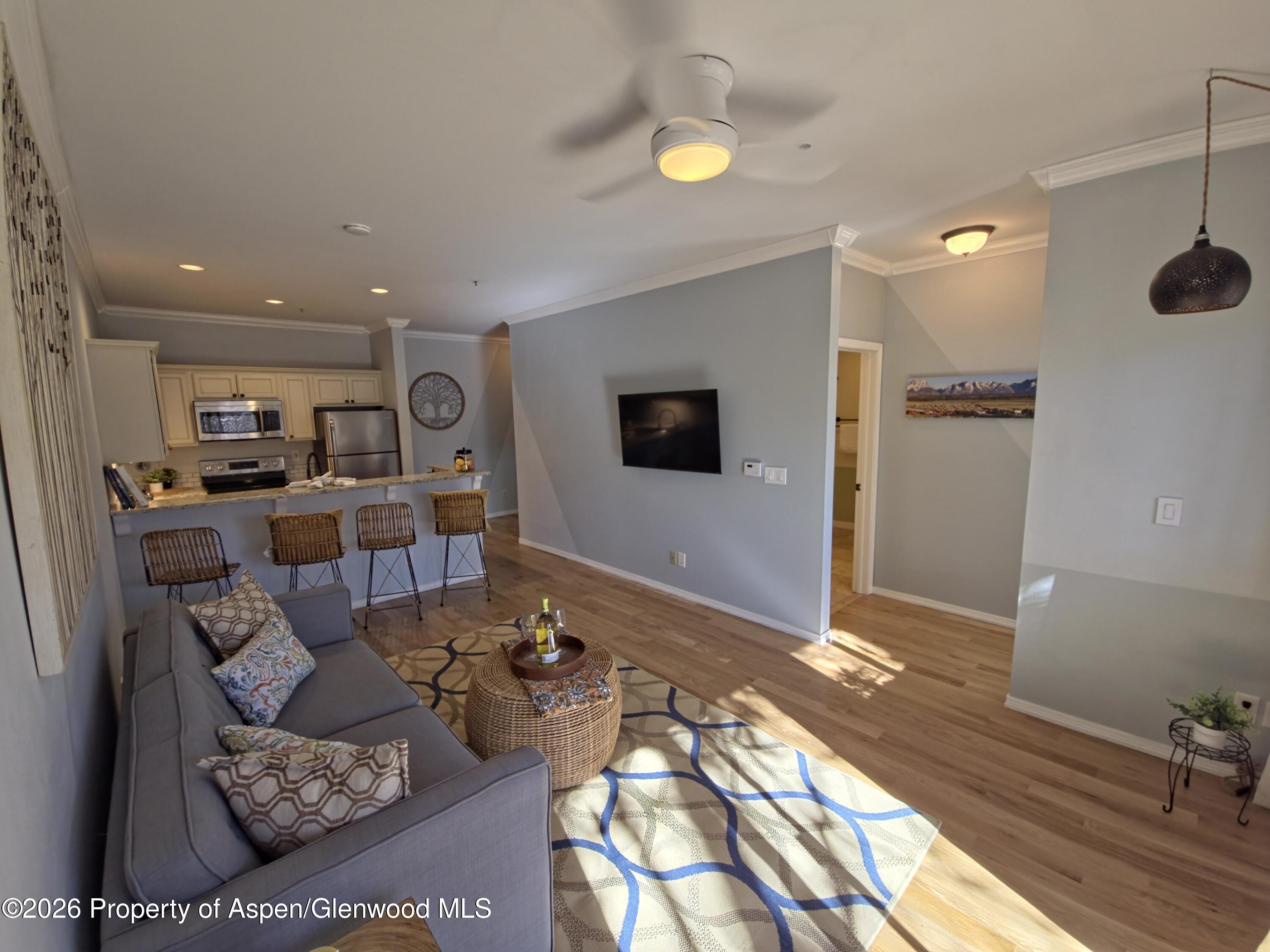 a living room with furniture and a flat screen tv