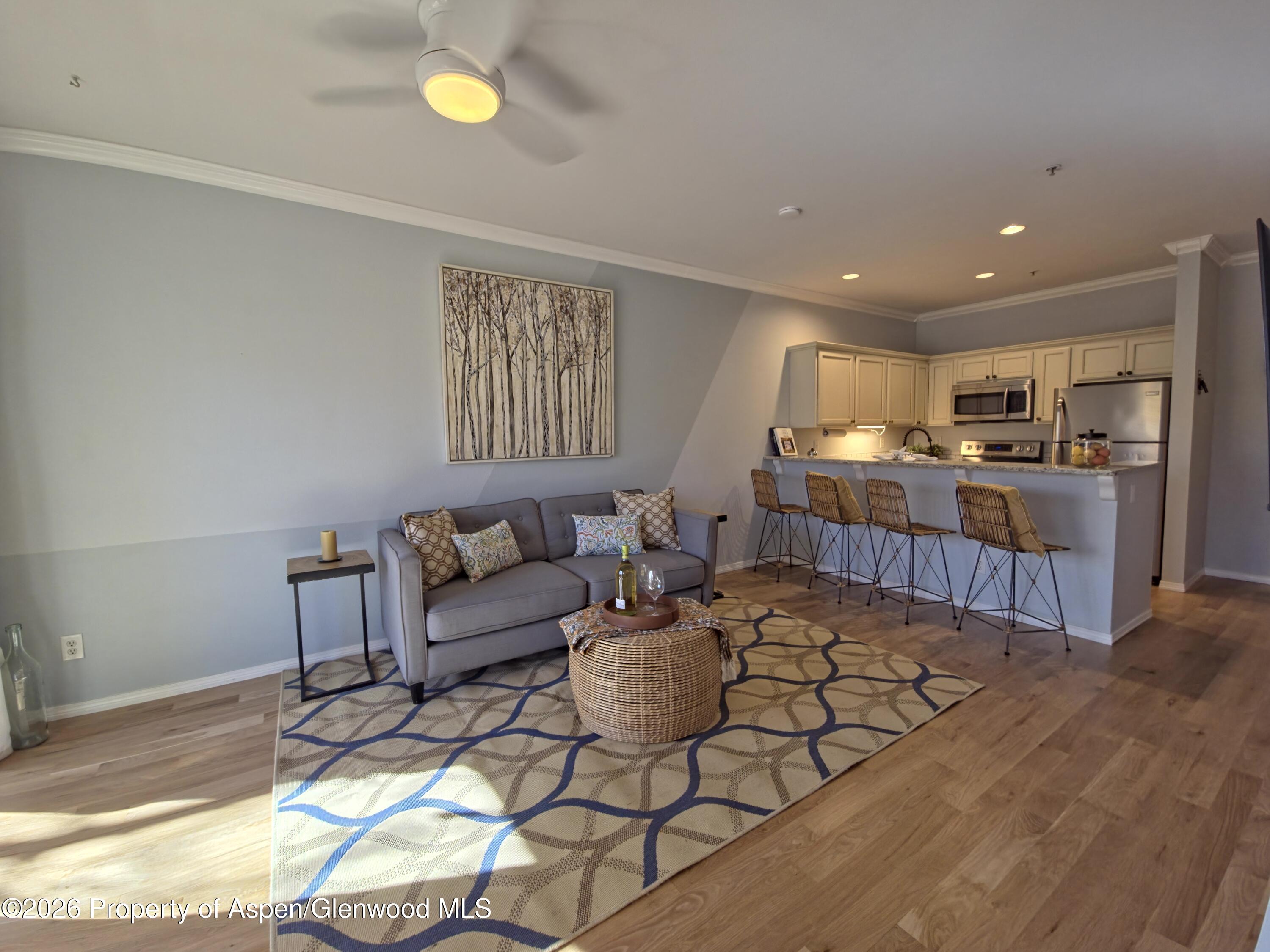 1400 East Valley Road, Unit 212 Basalt, CO 81621 - Photo 6 of 8 a living room with furniture and a table