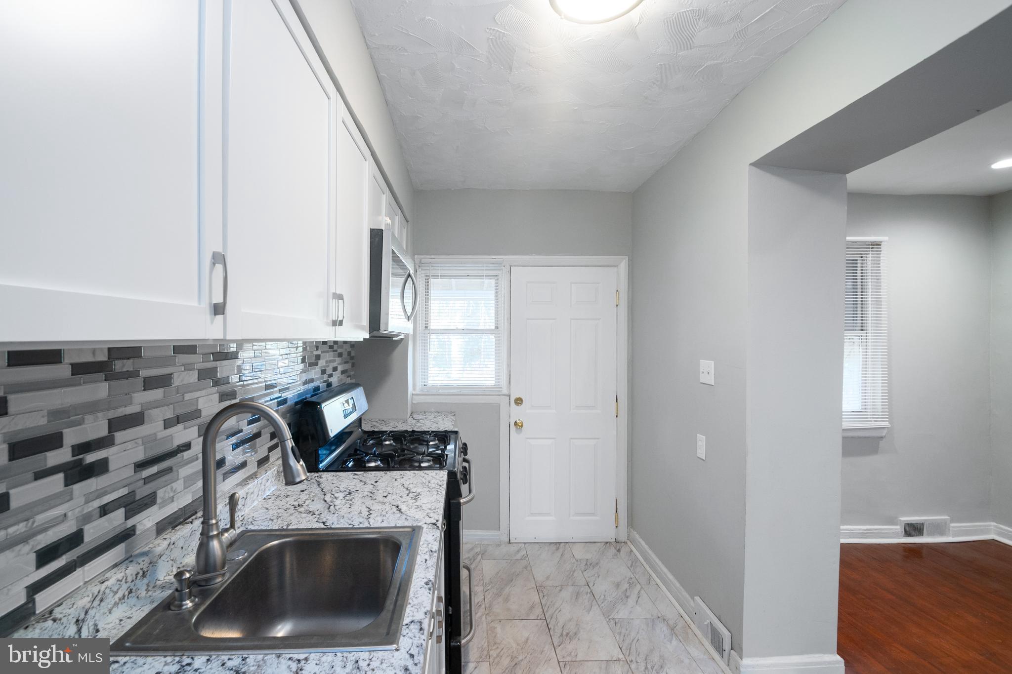 48 Hillvale Road Baltimore, MD 21229 - Photo 11 of 25 a kitchen with a stove and a refrigerator