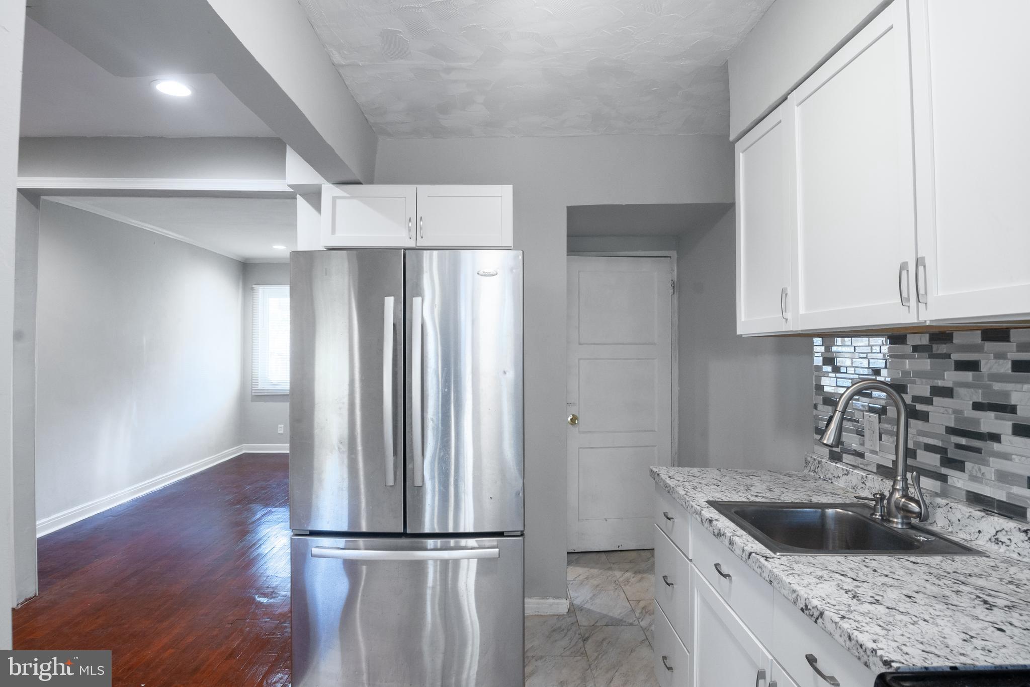 48 Hillvale Road Baltimore, MD 21229 - Photo 12 of 25 a kitchen with kitchen island a sink stove and refrigerator