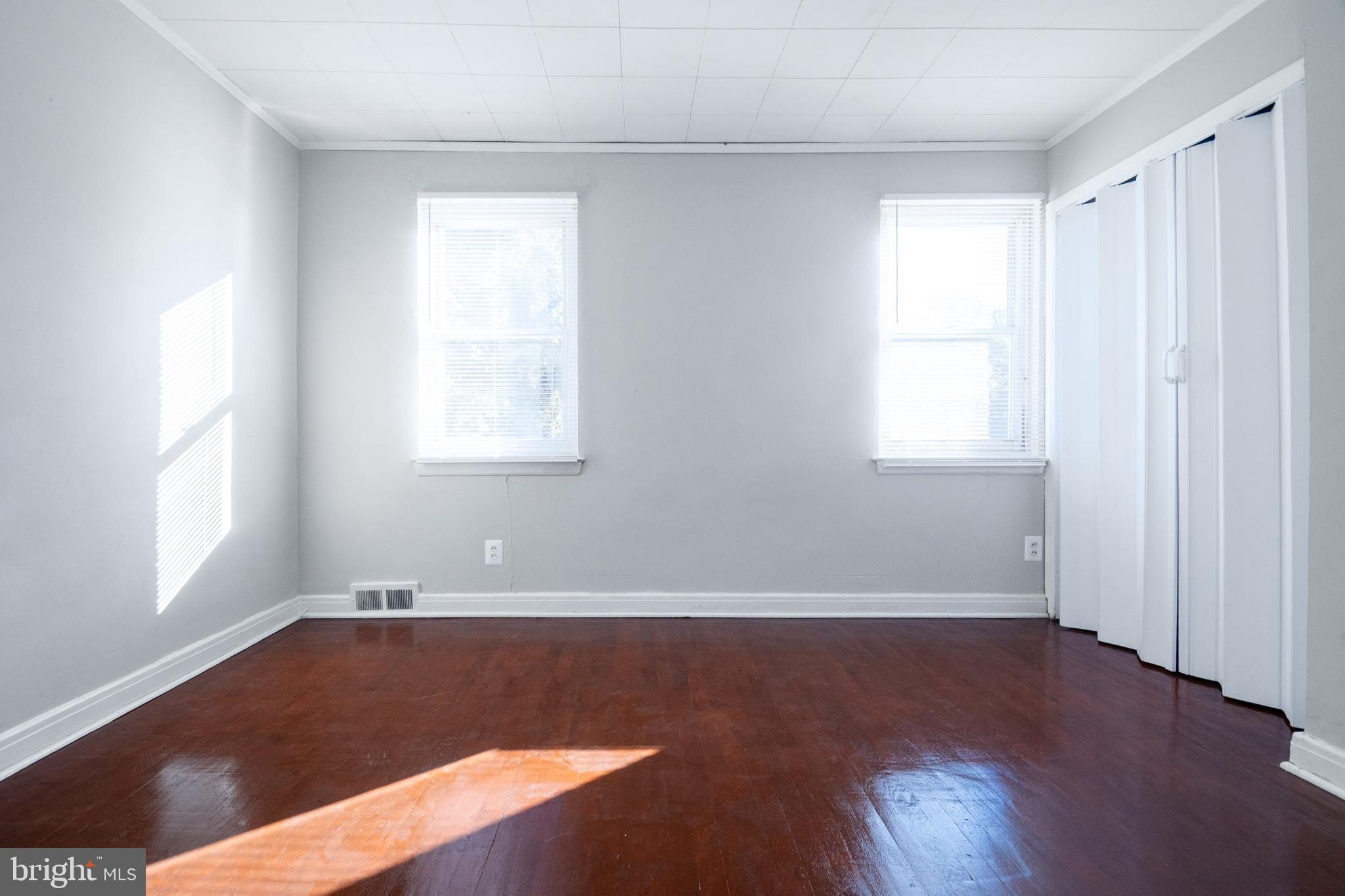 48 Hillvale Road Baltimore, MD 21229 - Photo 13 of 25 an empty room with wooden floor and windows