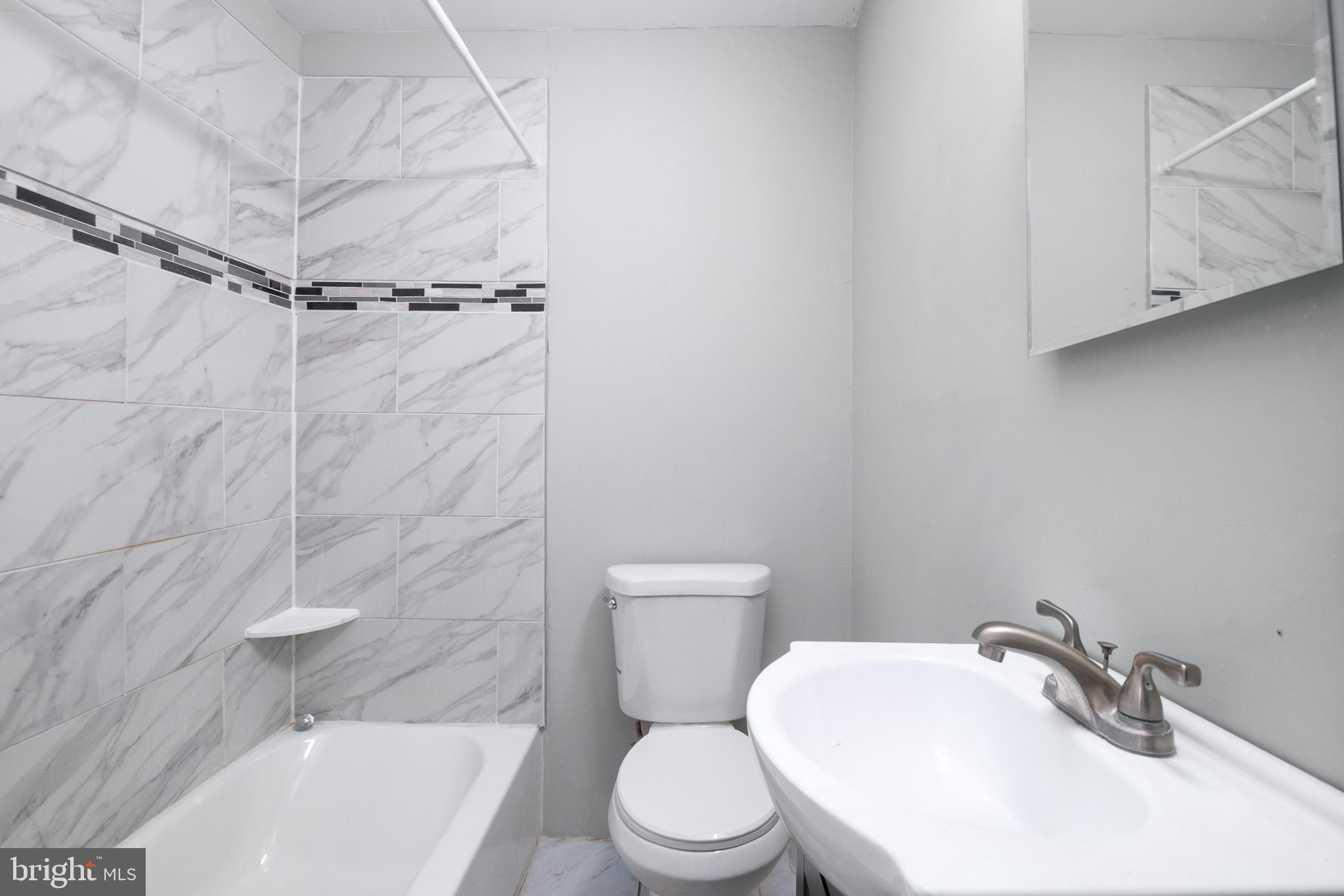 48 Hillvale Road Baltimore, MD 21229 - Photo 18 of 25 a white toilet sitting next to a bath tub