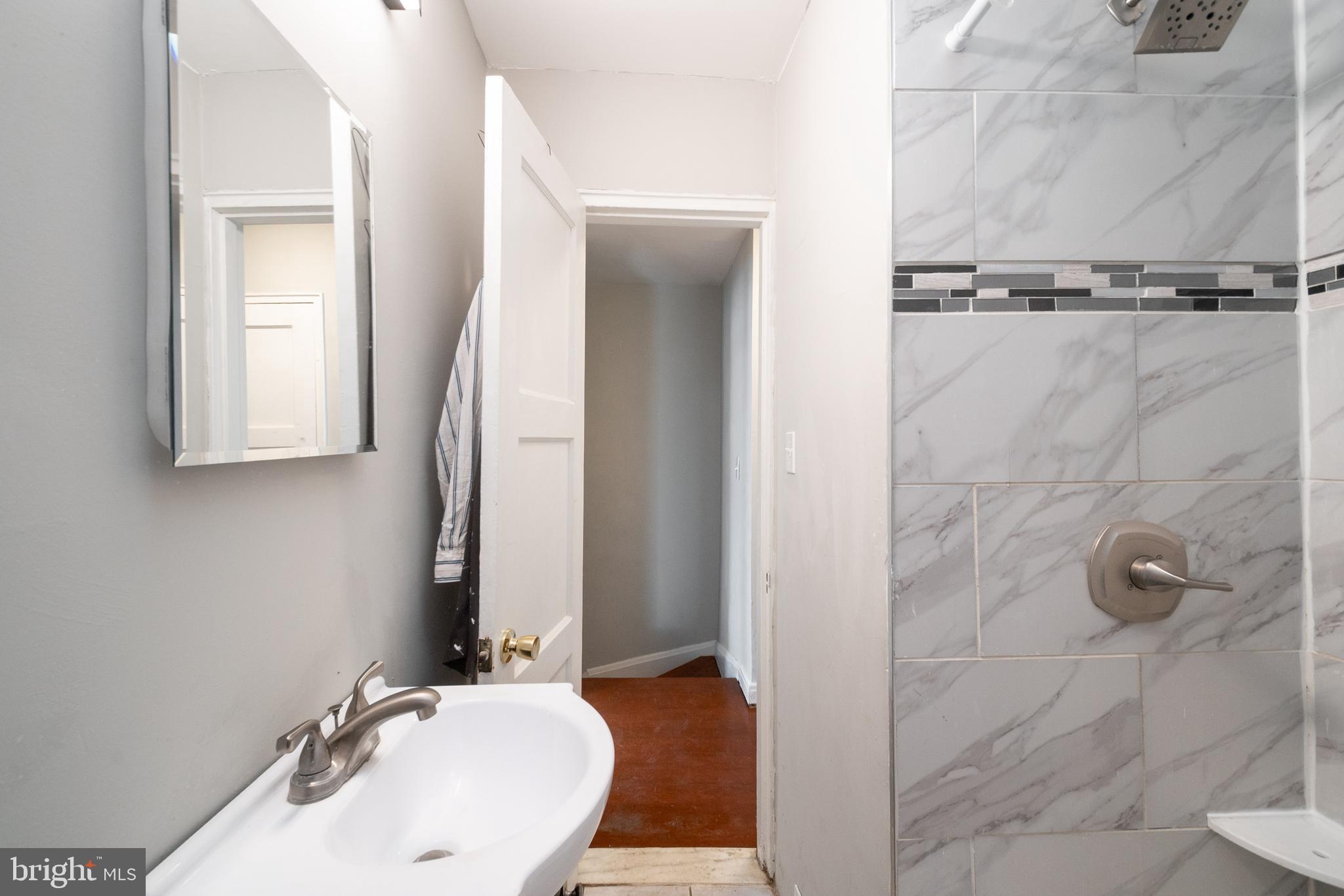 48 Hillvale Road Baltimore, MD 21229 - Photo 19 of 25 a bathroom with a sink and mirror