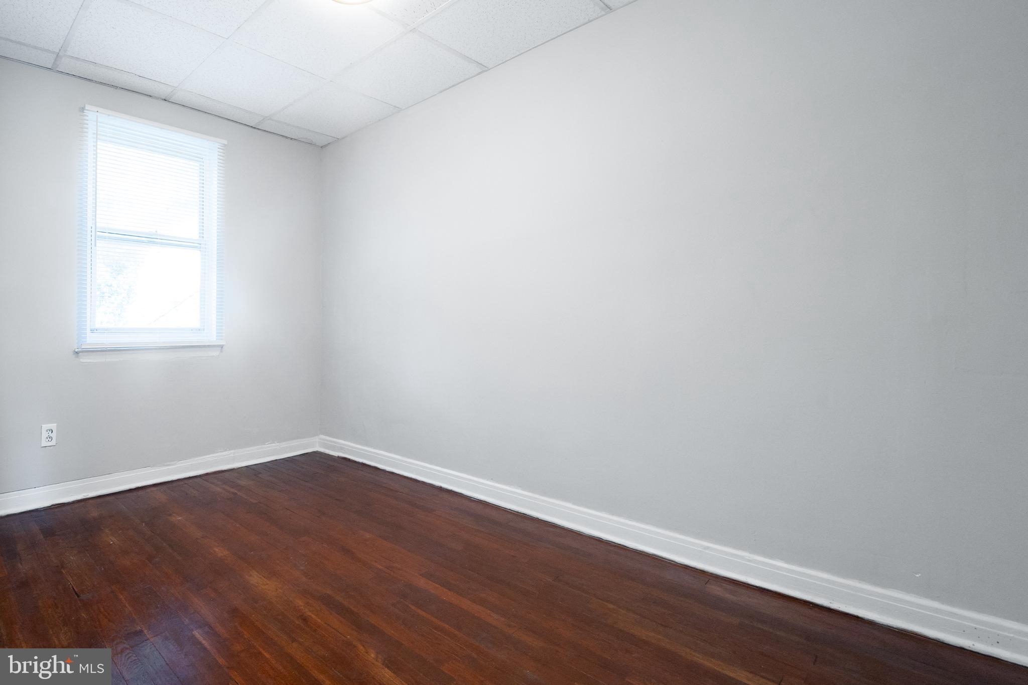 48 Hillvale Road Baltimore, MD 21229 - Photo 20 of 25 a view of an empty room with wooden floor and a window
