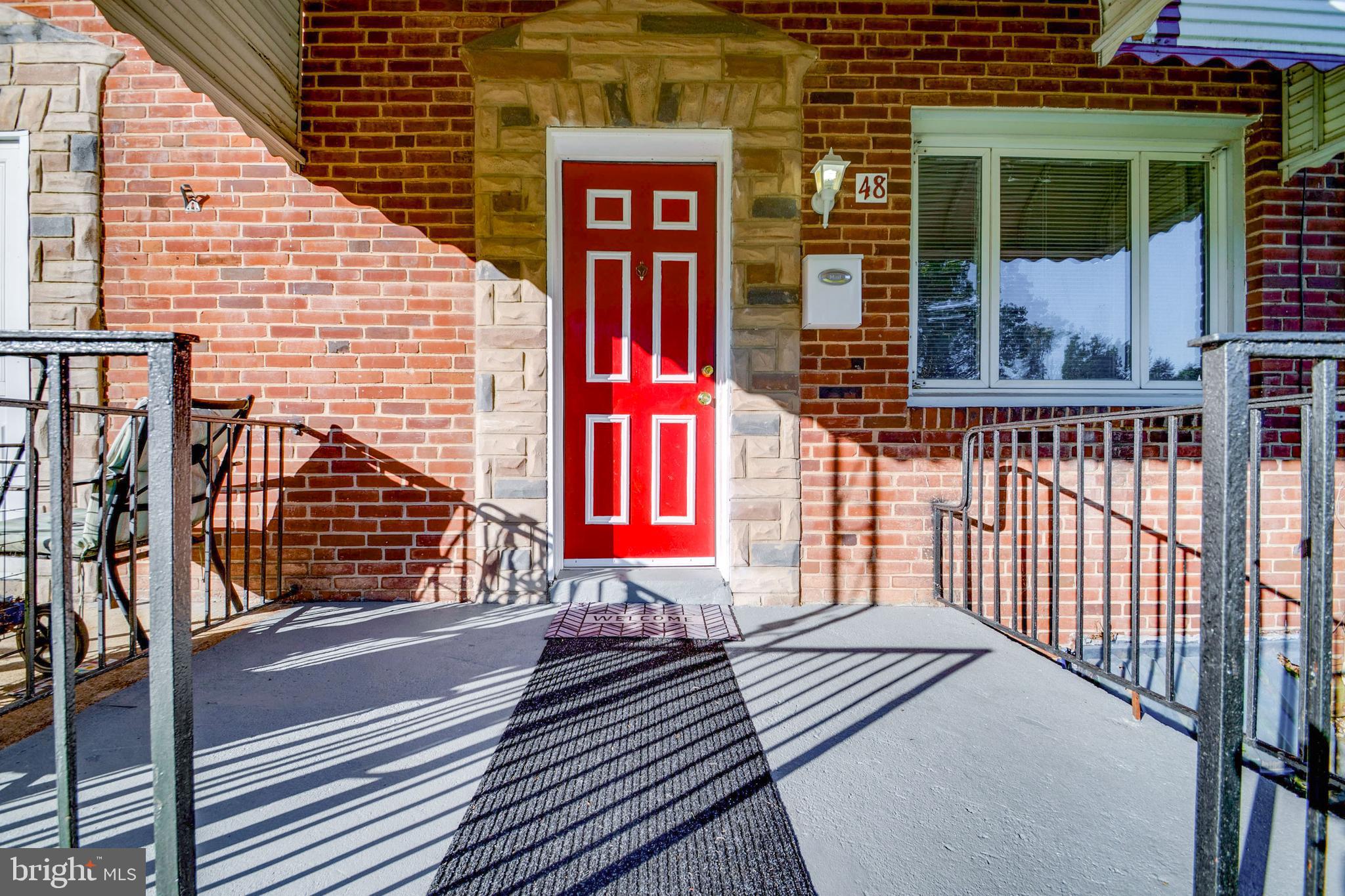 48 Hillvale Road Baltimore, MD 21229 - Photo 3 of 25 a view of a brick building with a small yard