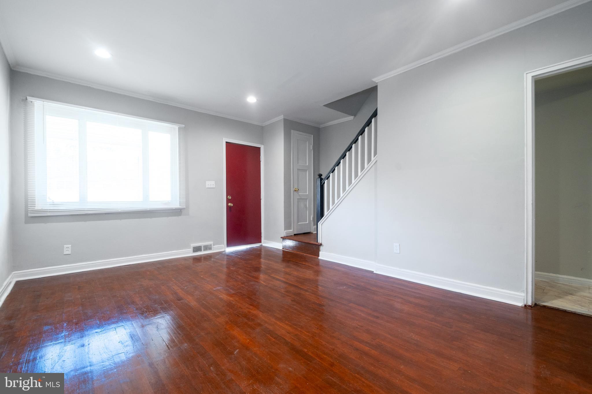 48 Hillvale Road Baltimore, MD 21229 - Photo 6 of 25 a view of an empty room with wooden floor and a window