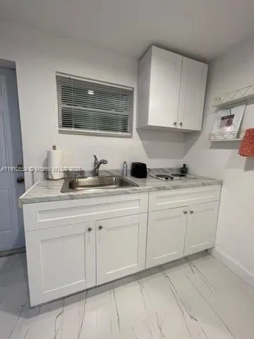 a kitchen with a sink stove and refrigerator