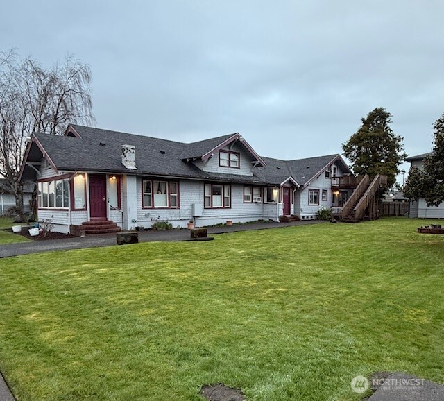 a front view of a house with a garden and porch
