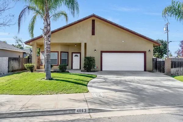a front view of a house with a yard and a garage