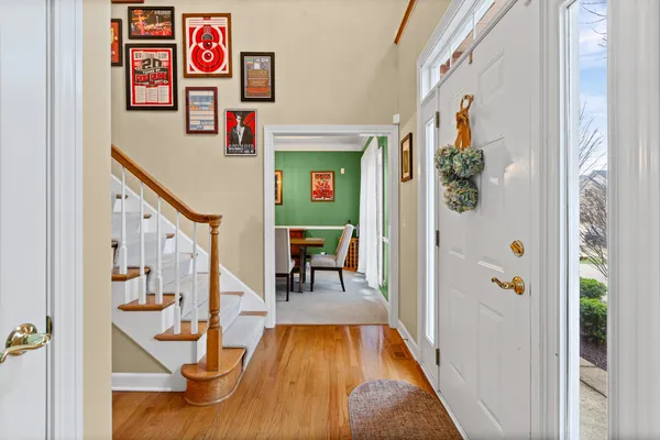 a view of a dining room and livingroom with furniture wooden floor a chandelier