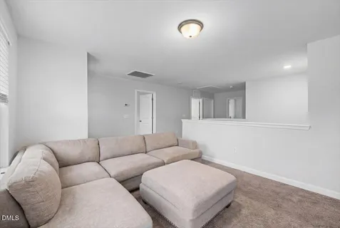 an empty room with fan and windows