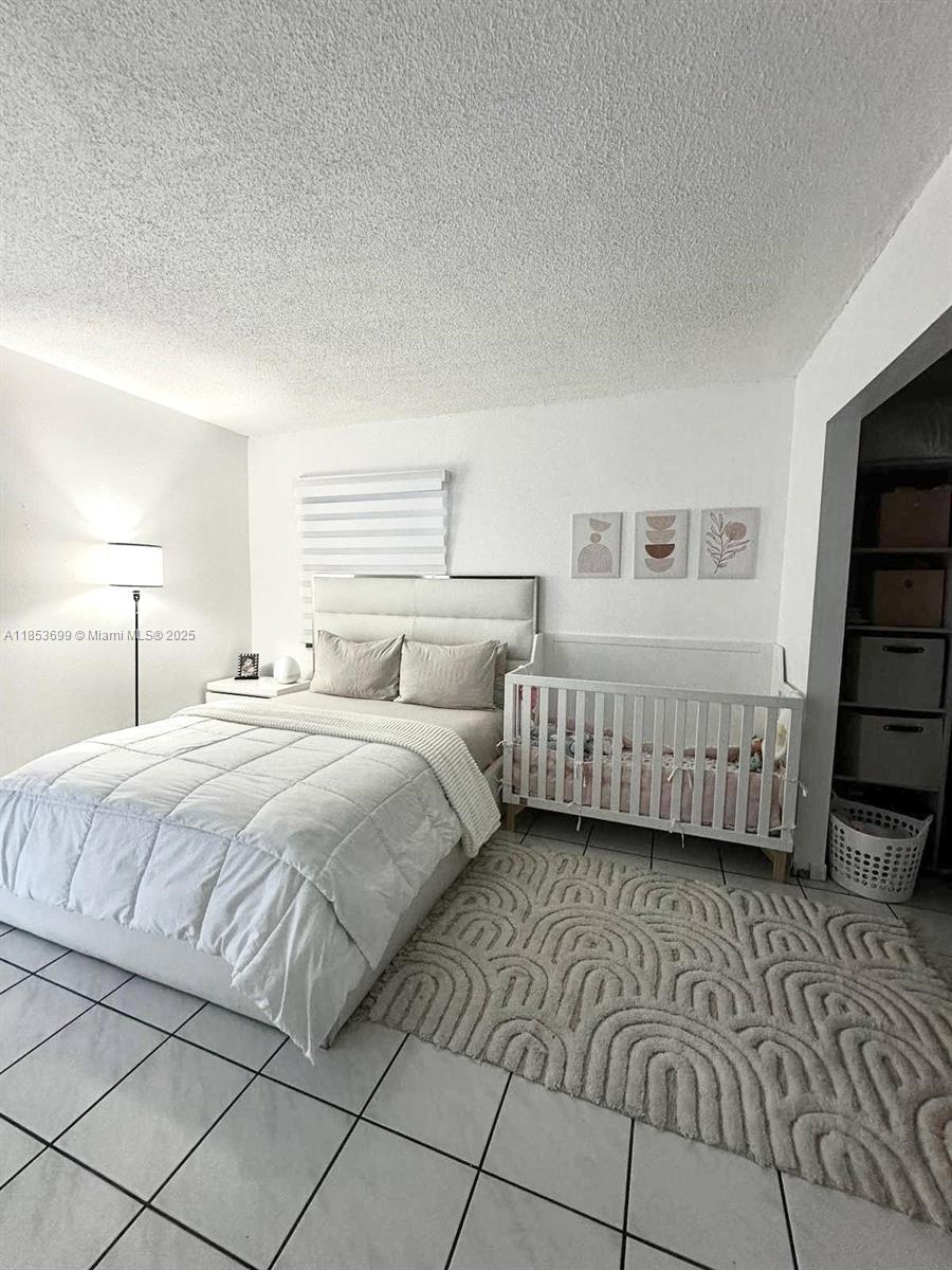 1750 West 46th Street, Unit 535 Hialeah, FL 33012 - Photo 17 of 28 a bedroom with double bed and a window
