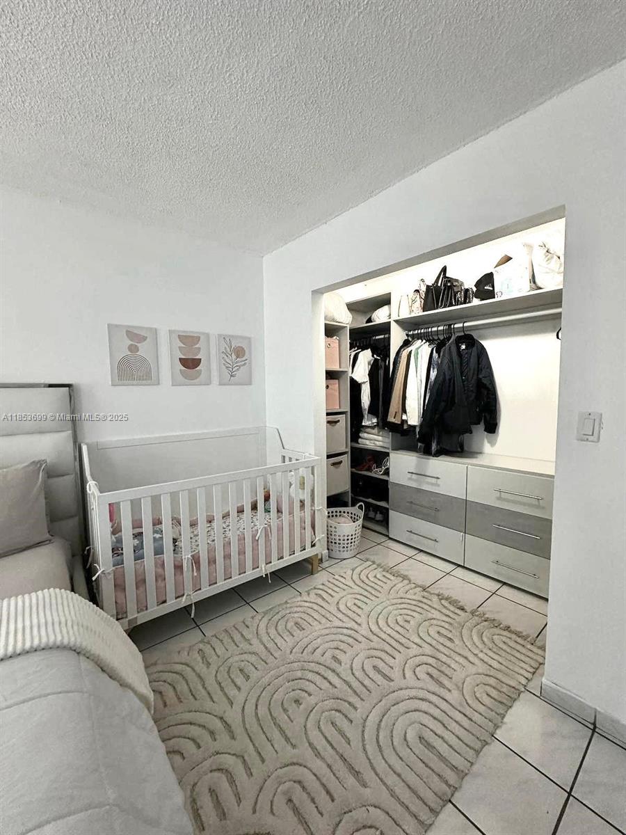 1750 West 46th Street, Unit 535 Hialeah, FL 33012 - Photo 18 of 28 a bedroom with furniture and walk in closet