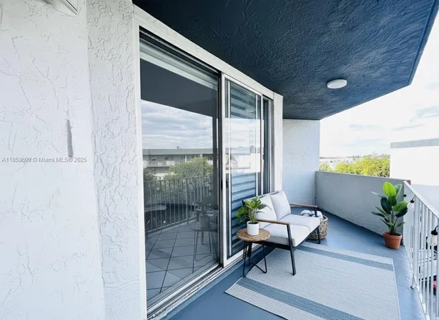 a balcony with furniture and a potted plant