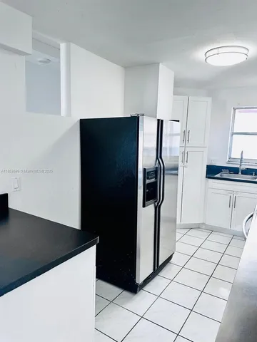 a kitchen with stainless steel appliances a refrigerator and a stove top oven
