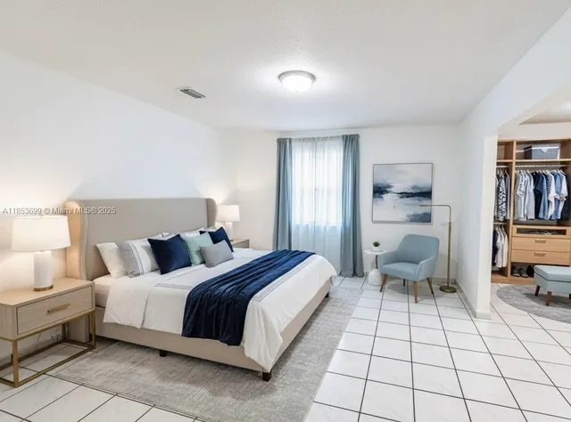 a bedroom with a bed and a view of bedroom