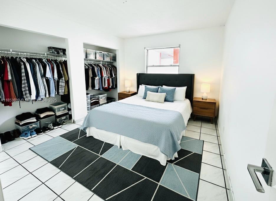 1750 West 46th Street, Unit 535 Hialeah, FL 33012 - Photo 8 of 28 a bedroom with a bed and a book shelf